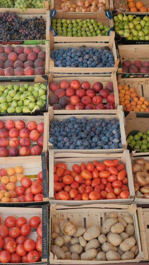 A display of fruit at the market like pears, apricots and peaches